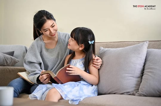 couple reading to their child-English enrichment classes Singapore